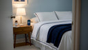 Nightstand with supplements and book in cozy bedroom