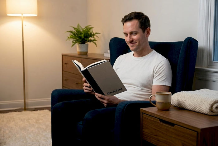 Man reading peacefully in softly lit living room