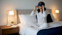 Woman adjusting sleep mask at bedtime
