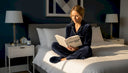 Woman reading in bedroom before sleep