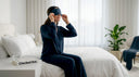 Woman putting on sleep mask in bedroom