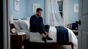 Man winding down before bed in calm bedroom