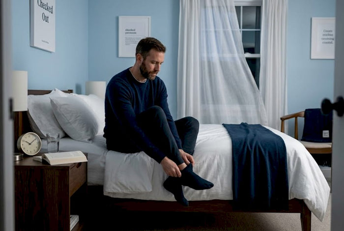 Man winding down before bed in calm bedroom