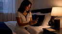 Woman setting wind-down alarm in bedroom
