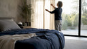 Person adjusting sleep-optimized bedroom curtains