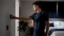 Man adjusting bedroom for performance sleep