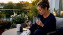 Woman reading supplement labels at home table