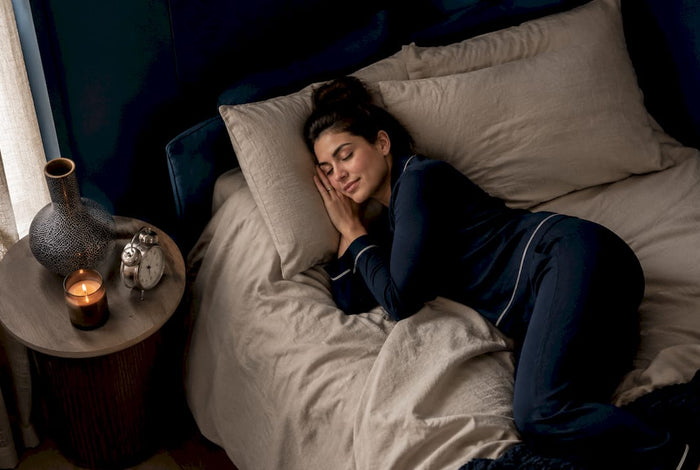 Woman preparing to fall asleep in cozy bedroom