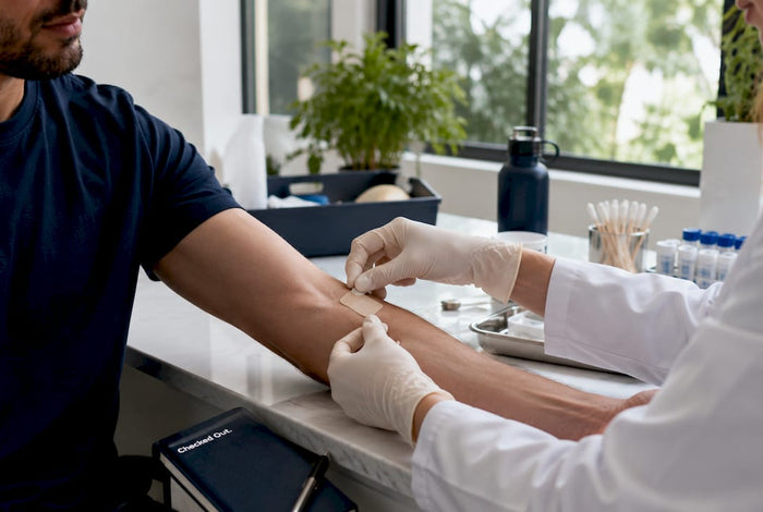 Hands applying transdermal drug patch on forearm