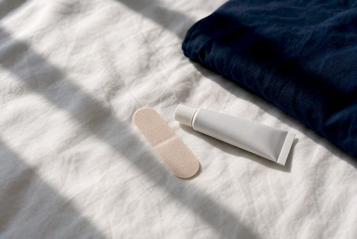 Mouth tape and ointment beside bedding