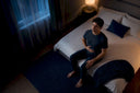 Person practicing slow breathing beside bed
