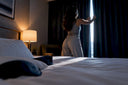 Hotel curtain seam leaking dawn light beside mask edge